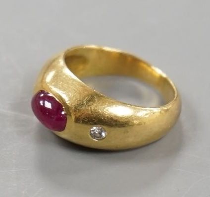 A yellow metal, cabochon ruby and two stone diamond chip set ring, size E/F, gross weight 6.6 grams.